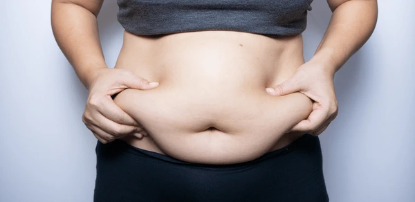 fat-woman-hand-holding-belly-600nw-2021002790